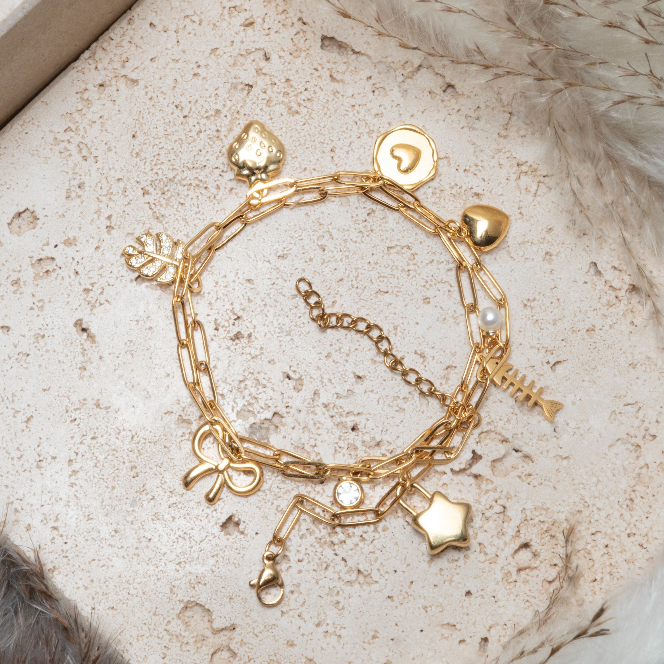 Gold charm bracelet  with lots of dangling charms. make your own at our charm bar in Calgary.